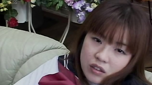 Asian schoolgirl in uniform rubbing her tits and hairy slit