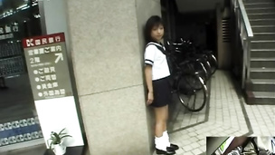 Barely legal Asian in school uniform sucking inside a restroom